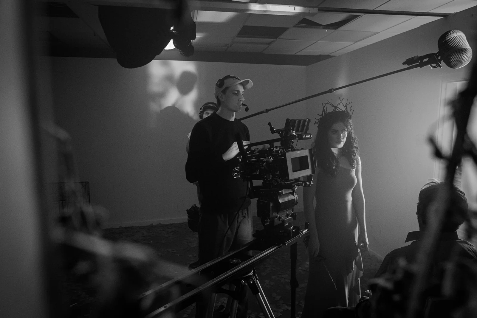 Camera and boom microphone surrounding the cast on set