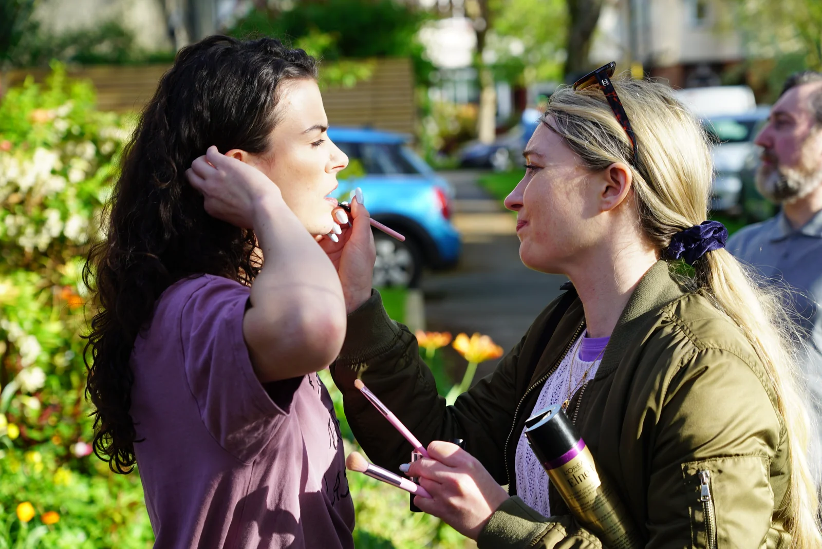 An outdoor makeup touch-up between takes