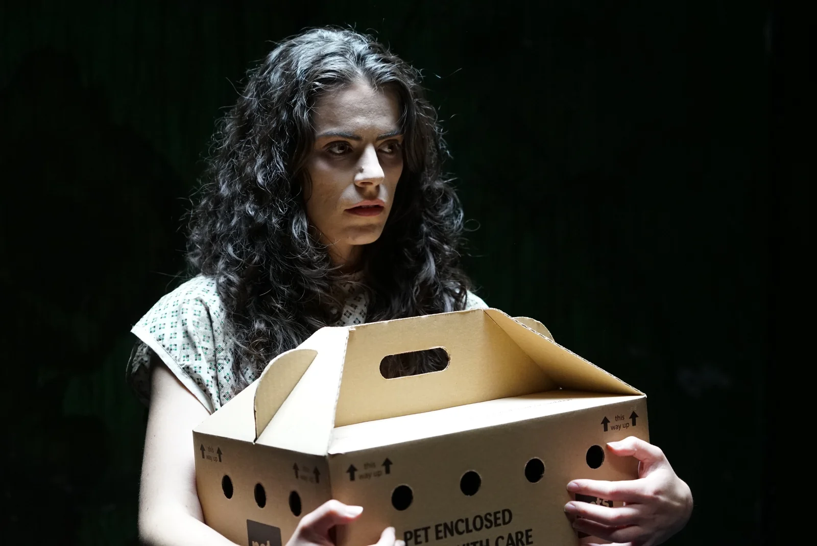 Cara in costume holding a cardboard pet carrier